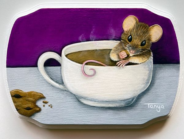 Mouse in coffee mug with cookie.