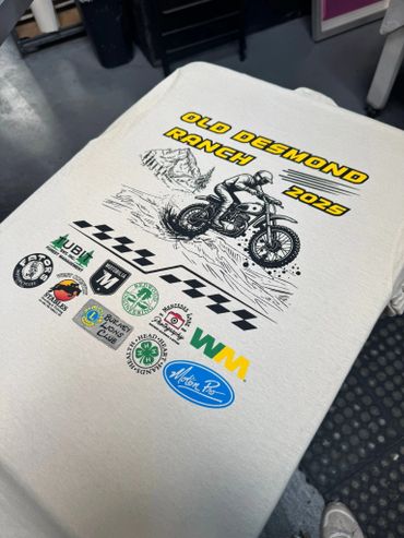 T-shirt with Old Desmond Ranch 2025 motorcycle design and sponsor logos.