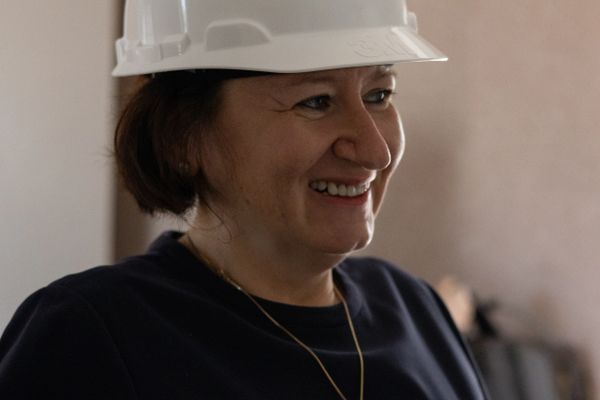Woman smiling in white construction hat
