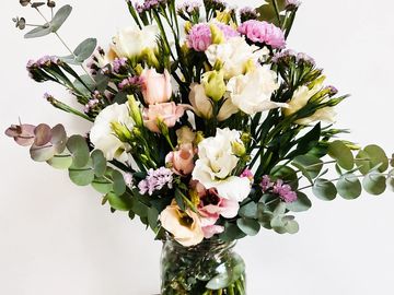 A bouquet of mixed flowers in a clear vase.