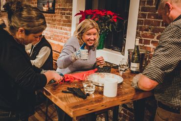 A lady giving thumbs up after shucking an oyster in Maine