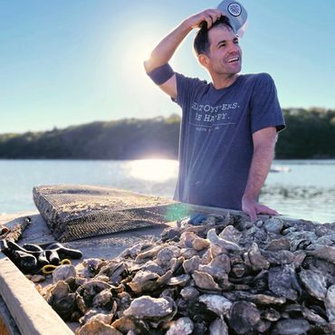 An oyster farmer working on a floating dock in Phippsburg, Maine.
