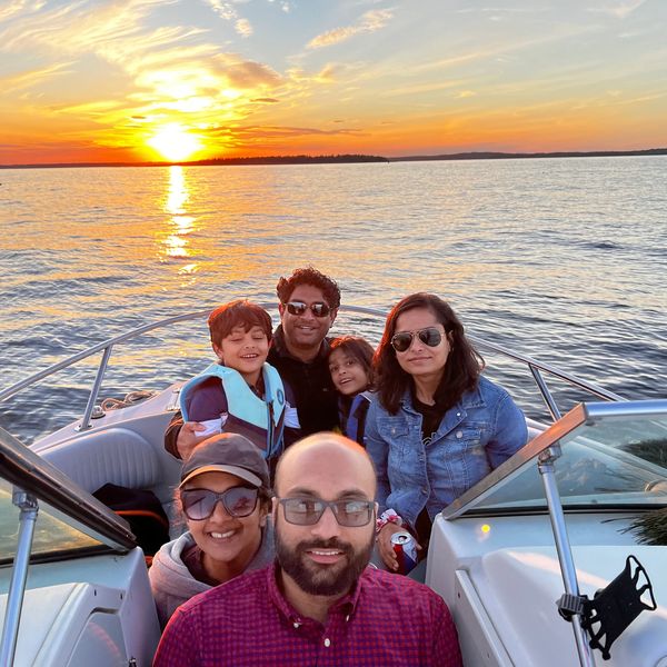 A family on a sunset oyster farm tour in Phippsburg, Maine