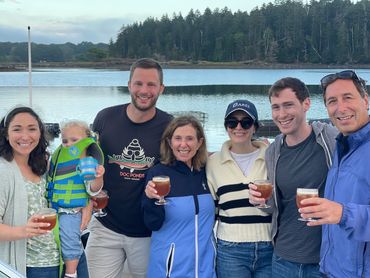 A group of people enjoying a cocktail on the dock in West Point Maine