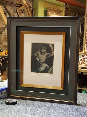Restored antique photograph displayed in a custom frame.