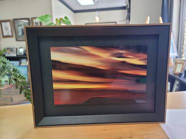custom framed sunset photograph with dark frame