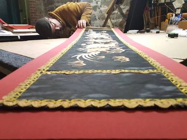 Fabric art panel custom framed to preserve delicate textile materials.