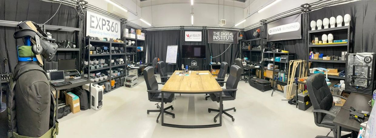 Modern workspace with multiple chairs and tech equipment.