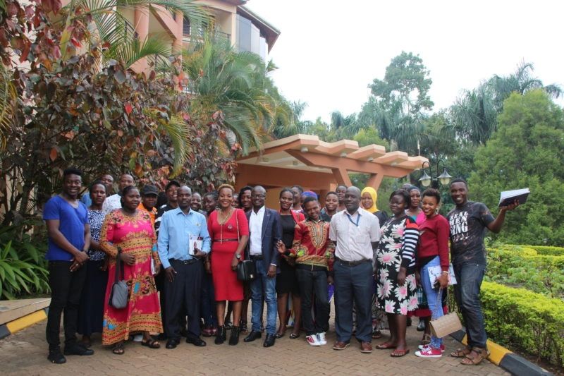 Group photo of people outdoors near a building.