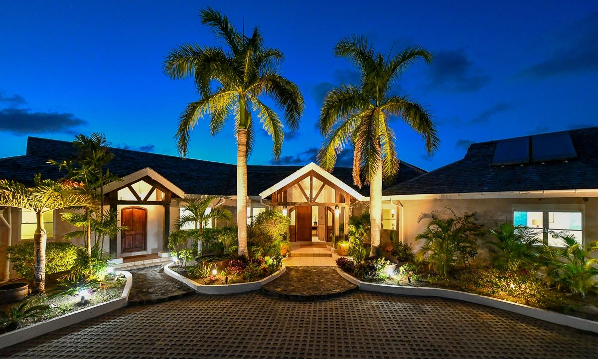 Bluff House front entrance with large palm trees and plenty of parking
