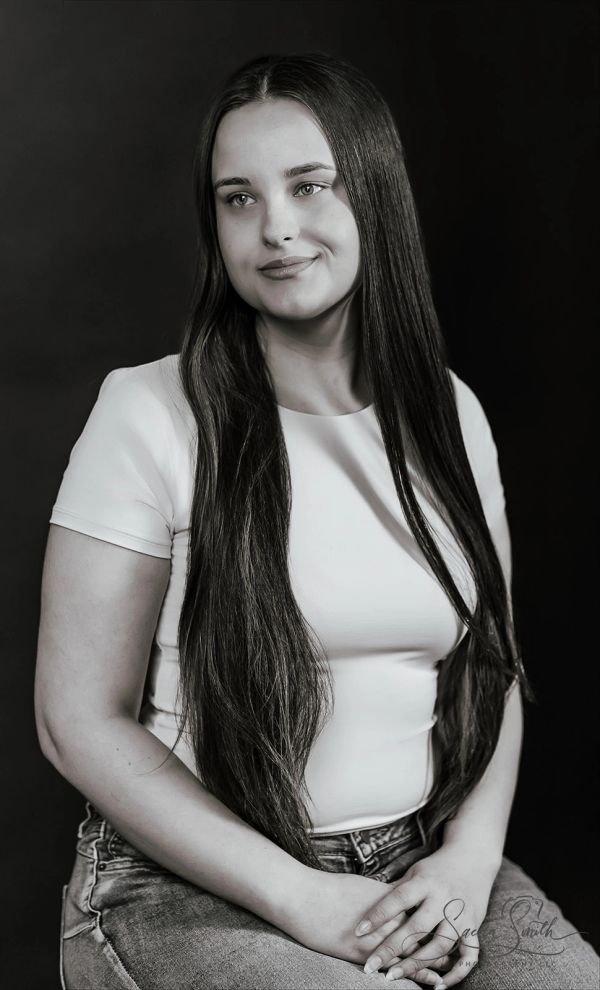 Black and white portrait of a woman with long hair and a gentle smile.