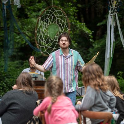 Storyteller outdoors in a wooded setting