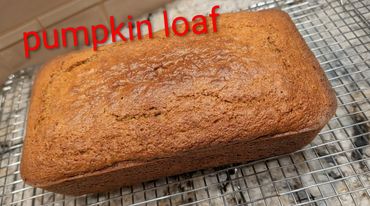 Freshly baked pumpkin loaf cooling on a wire rack.