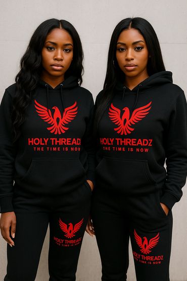 Two women wearing matching black hoodies and pants with red Holy Threadz logos.