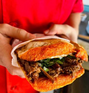 Close-up of a sandwich with meat and greens.