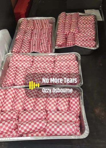 Trays of wrapped sandwiches.