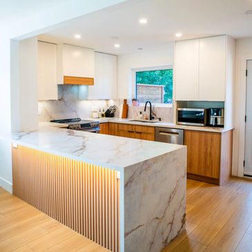 Modern kitchen renovation with marble countertops and quality kitchen cabinets.