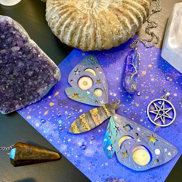 Mystical moth art and crystals on a cosmic background.