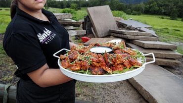 Server carrying tray of chicken wings