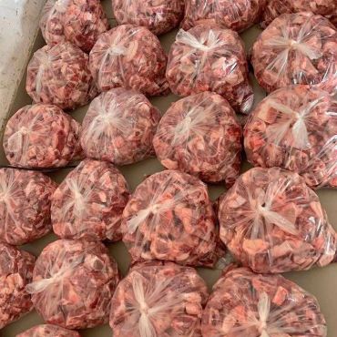 Several plastic bags filled with raw ground meat.