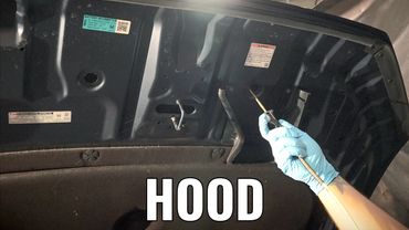 Inner hood of fleet vehicle getting rustproofing corrosion protection for fleet cars, trucks, suvs.