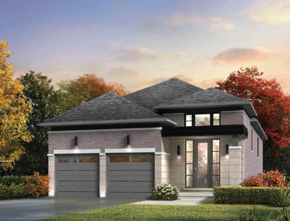 Modern two-story house with double garage and autumn landscaping.