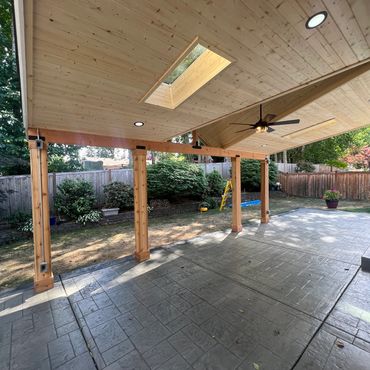 large patio cover in back yard attached to the house. patio cover with a roof.
