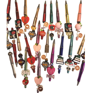 Assortment of teacher-themed pens decorated with apples, coffee cups, and books.