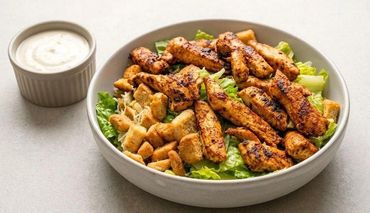 Grilled chicken Caesar salad with dressing on the side.