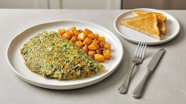 Spinach omelette with seasoned potatoes and toast.