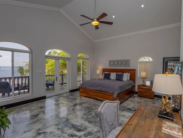 Spacious bedroom with ocean view and modern decor.