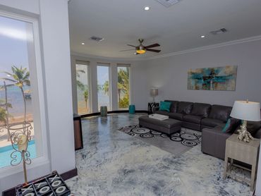 Modern living room with ocean view and leather sectional sofa.
