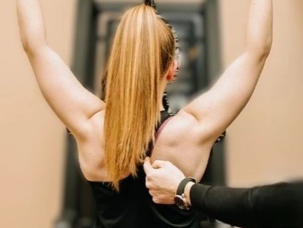 Person receiving shoulder massage.