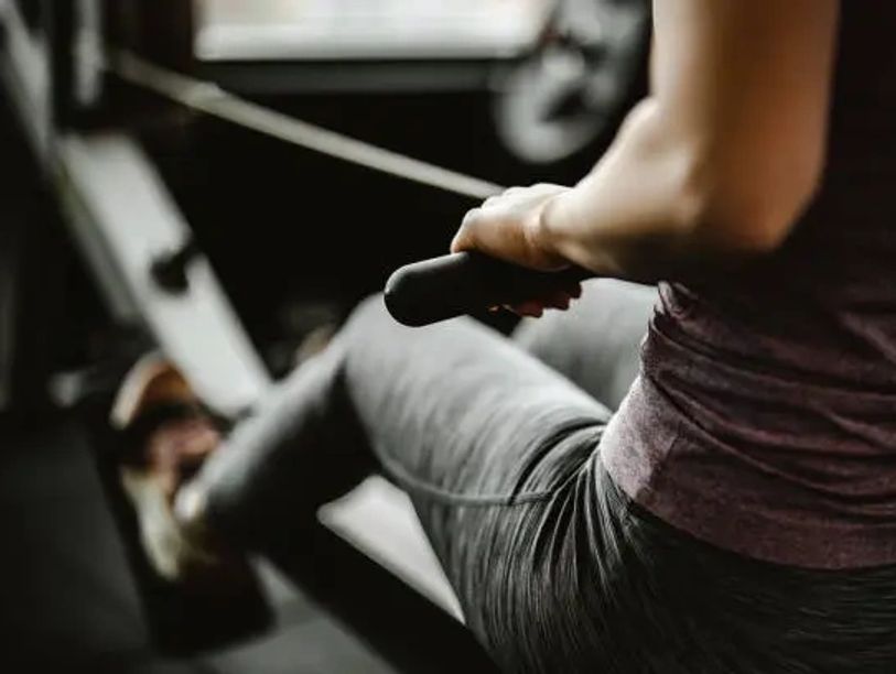 Person exercising on a rowing machine.