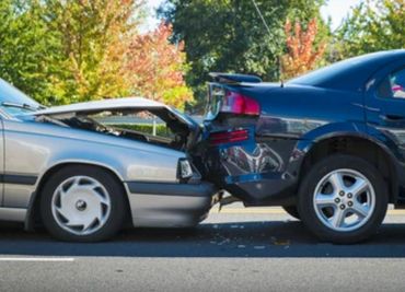 Two cars involved in an auto collision.