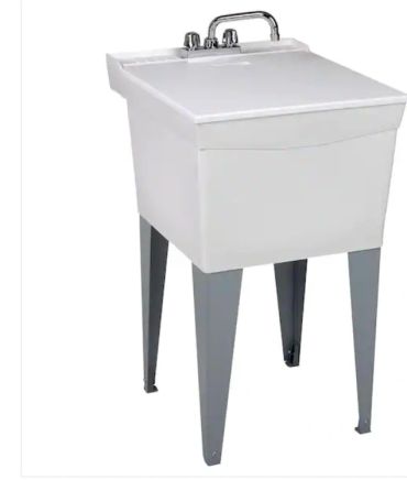 Utility laundry sink with faucet and metal legs.
