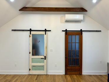 Antique barn doors in bright white room.