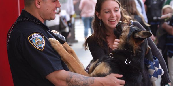 NYPD officer with K-9 greeting young woman. 
Image:  @deanball via Twenty20