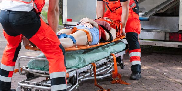 EMT's/ paramedics loading an accident victim onto a gurney. 
Image: bialasiewicz @Envato