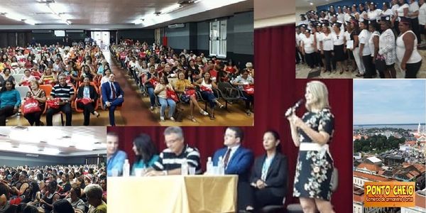 A large conference with a panel and an audience in a spacious hall.