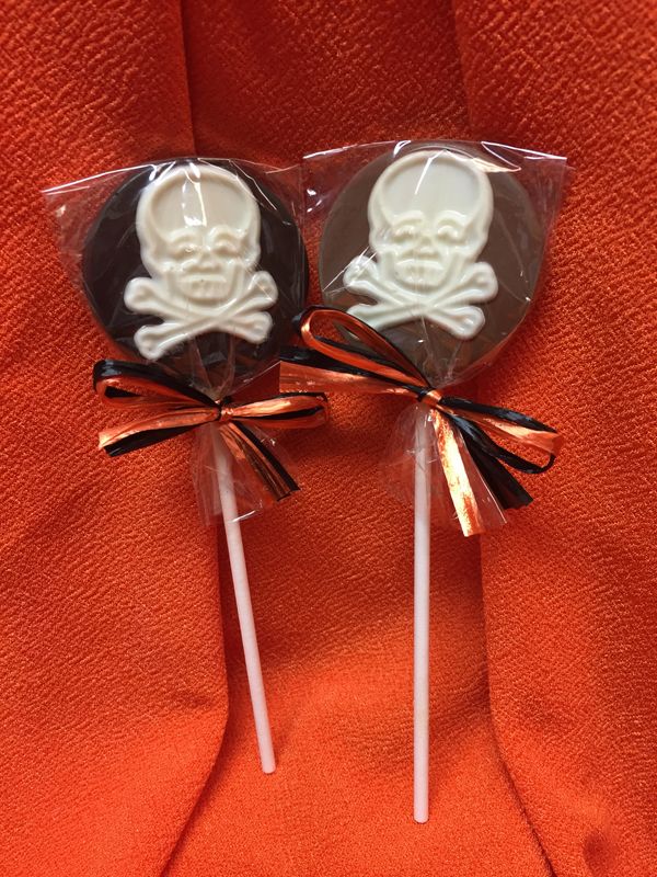 milk or dark pop with white skull and cross bones, tied in halloween colors.