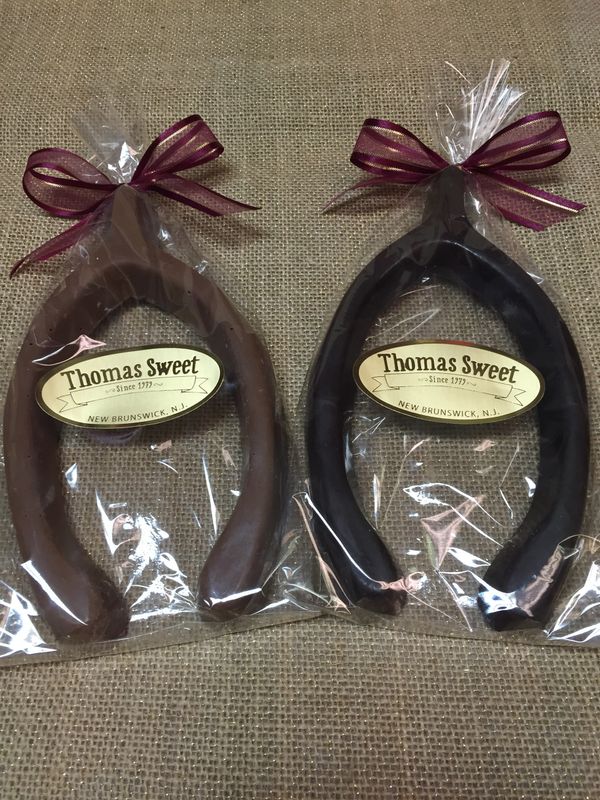 Milk and dark chocolate wish bones tied in burgundy.