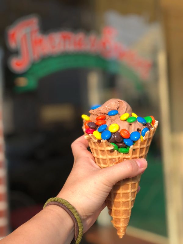 Double scoop of chocolate ice cream with m&m's on top in our homemade waffle cone.