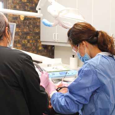 Dr Sharon Chun, implant dentist, during extraction and dental implant surgery for dental emergency