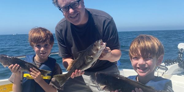 Finn, Leo, and their father with nice catches