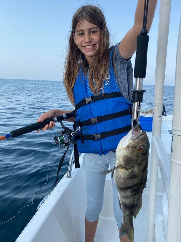 Young girl with her biggest fish of the day