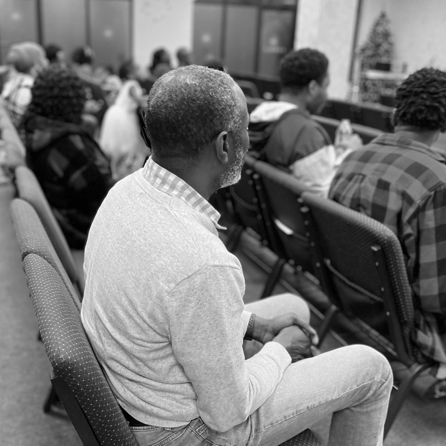 Man sitting in church service listening to sermon