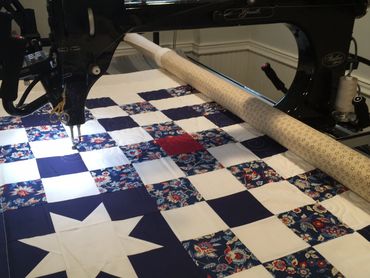 Edge to edge work on a Veteran’s quilt of Valor.