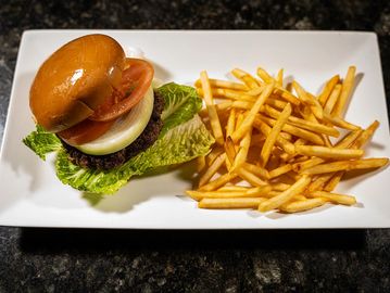 Juicy grilled beef patty served on a soft bun with classic toppings. A timeless favorite. Served wit