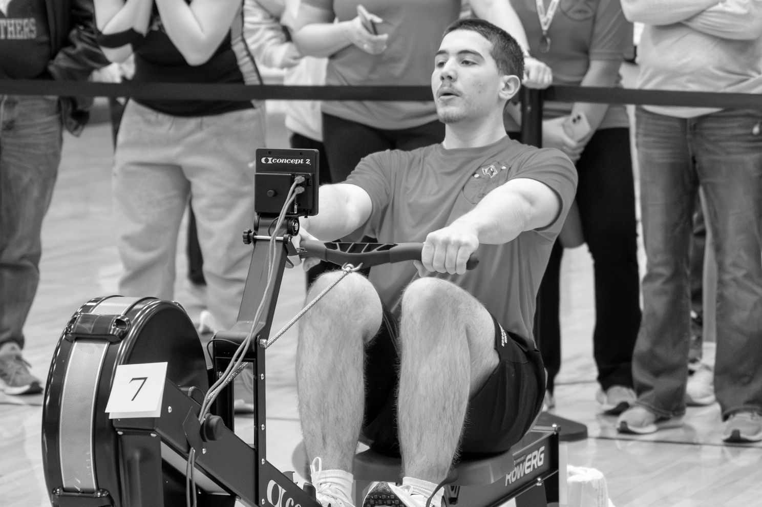 Man using a rowing machine during a competition.